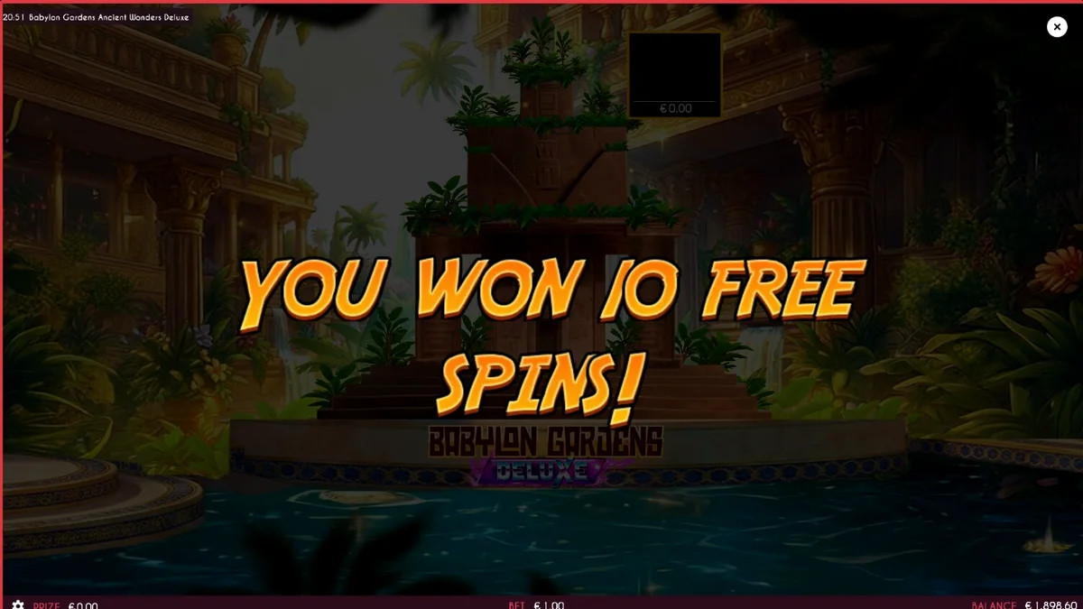 The reels of Babylon Gardens Ancient Wonders Deluxe set against a desert backdrop